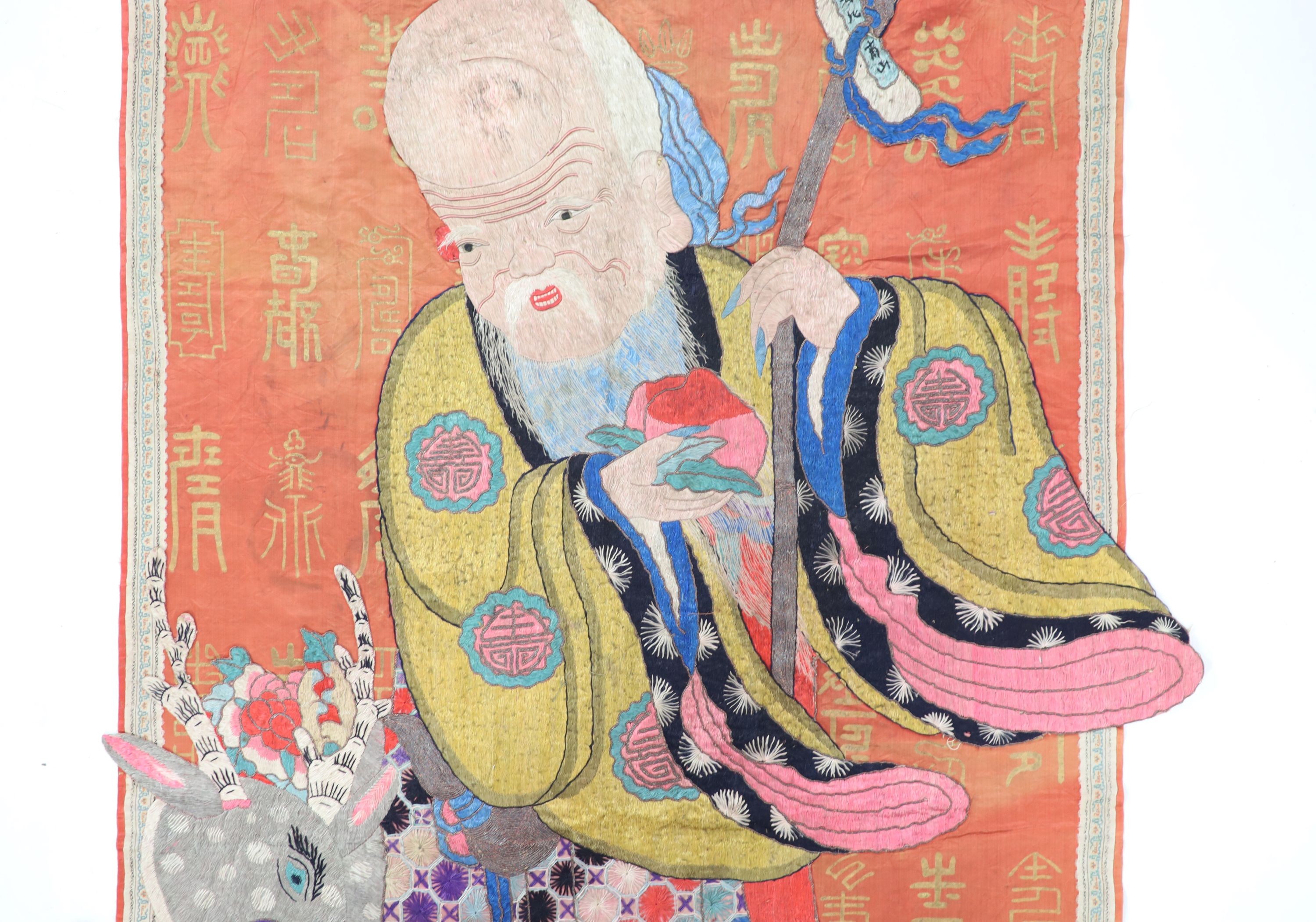 A Chinese embroidered silk ‘Shou Lao’ panel, late 19th century, 168 cm x 77 cm